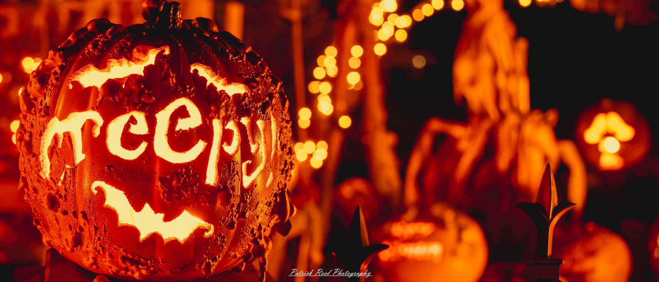 Taken on Tilson Street in Romeo Michigan on Halloween. "Close-up image of a carved Halloween pumpkin with the word 'creepy' illuminated on the front, glowing in a dark, eerie setting."